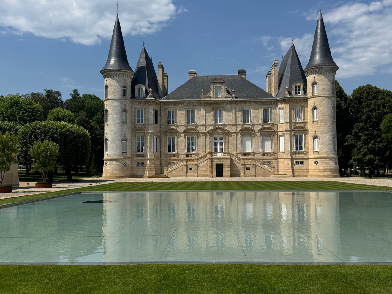 Bordeaux château reflected in its ornamental pool