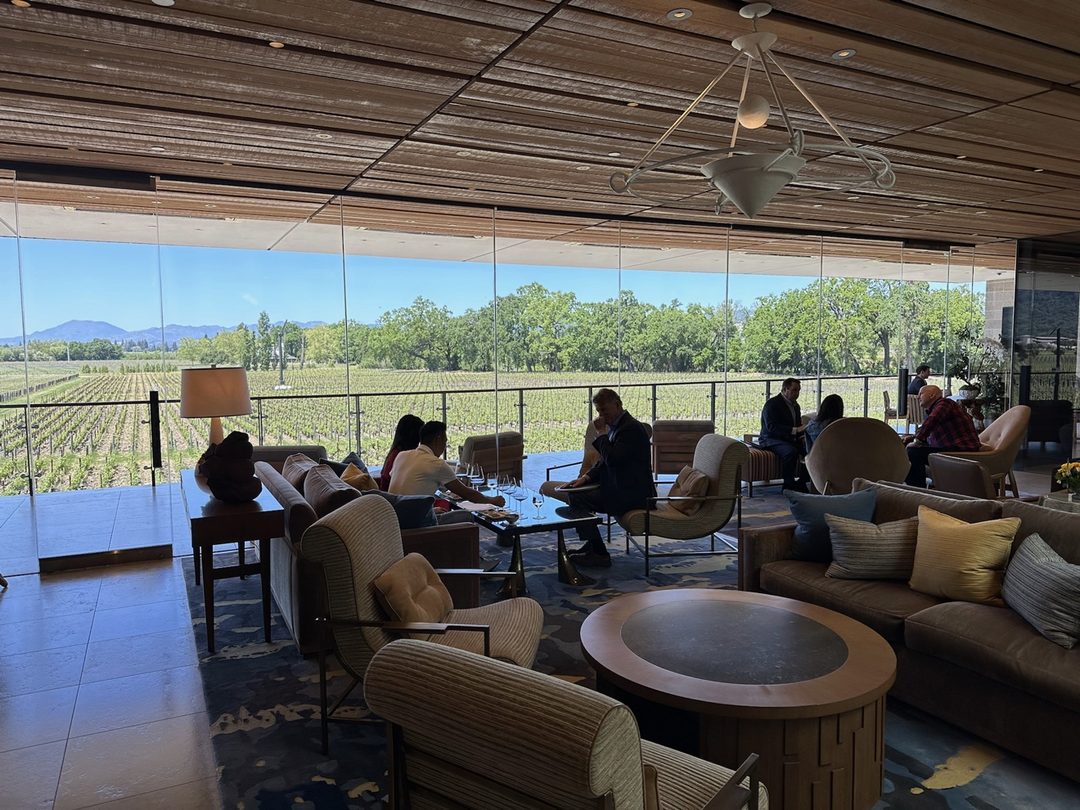 The Partners&rsquo; Room at Opus One: sofas and armchairs behind a glass wall looking over the estate vines
